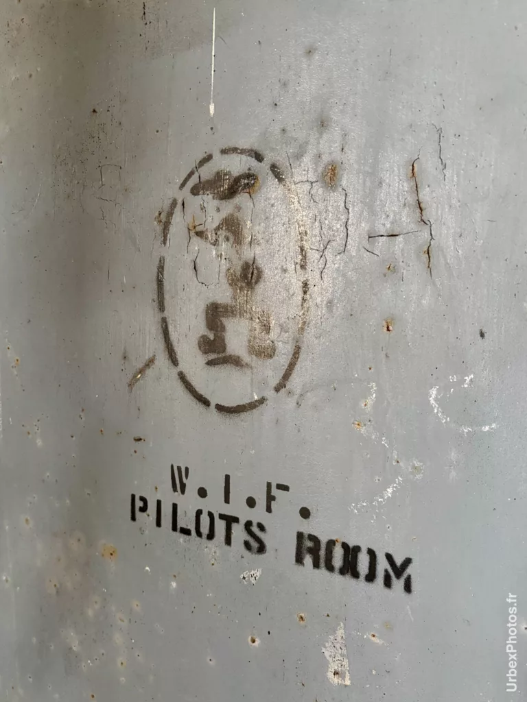 Mention salle des pilotes peinte au pochoir sur une porte d'une ancienne base de l'OTAN